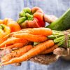 Fresh wet vegetables in gardeners hands